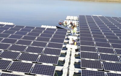 Solar panels float on blue grey water