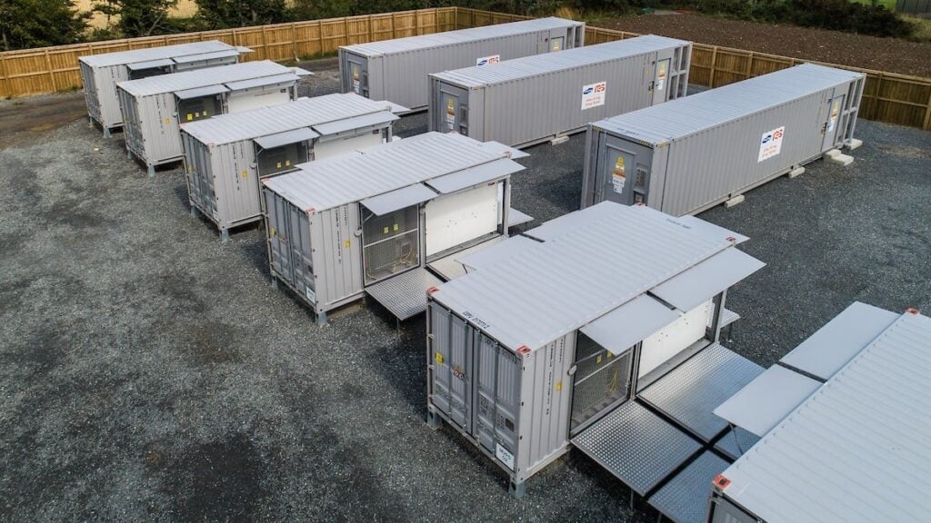 Battery energy storage units in rows on grey ground