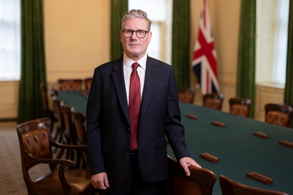 UK prime minister Kier Starmer stands in a conference room facing the camera