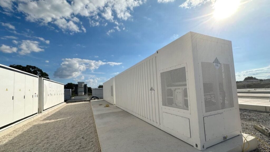 a series of bess units under a blue sky