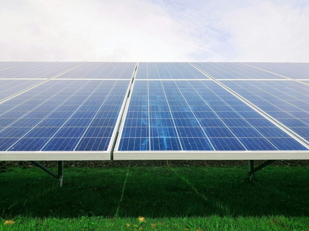 A close up of solar panels, shot from a low angle and sloping away from the camera