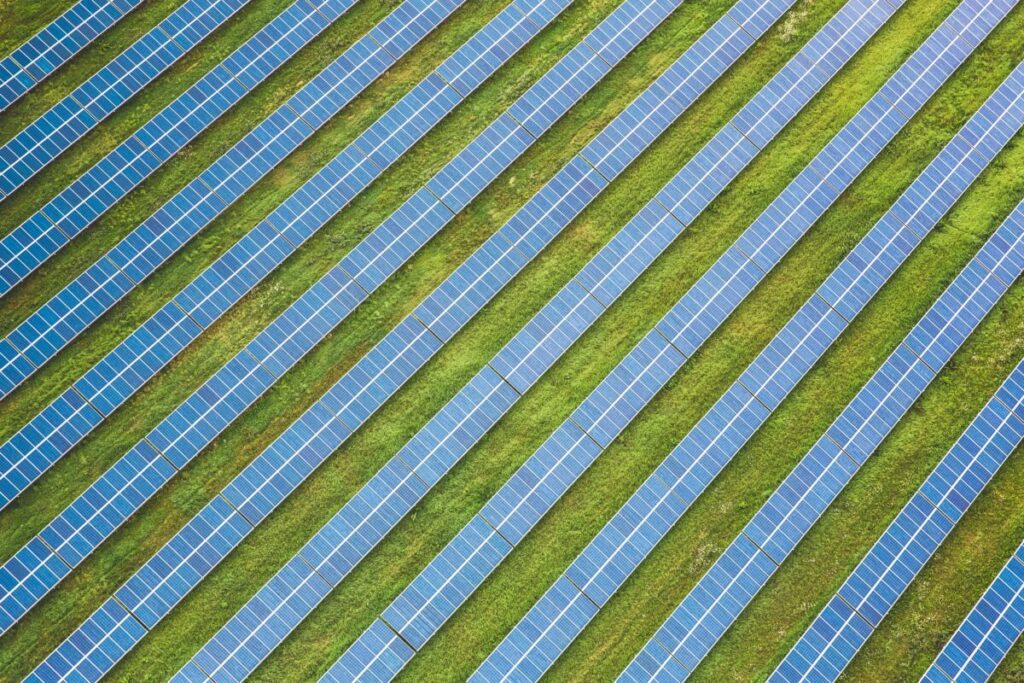Solar panels viewed from above on green fields