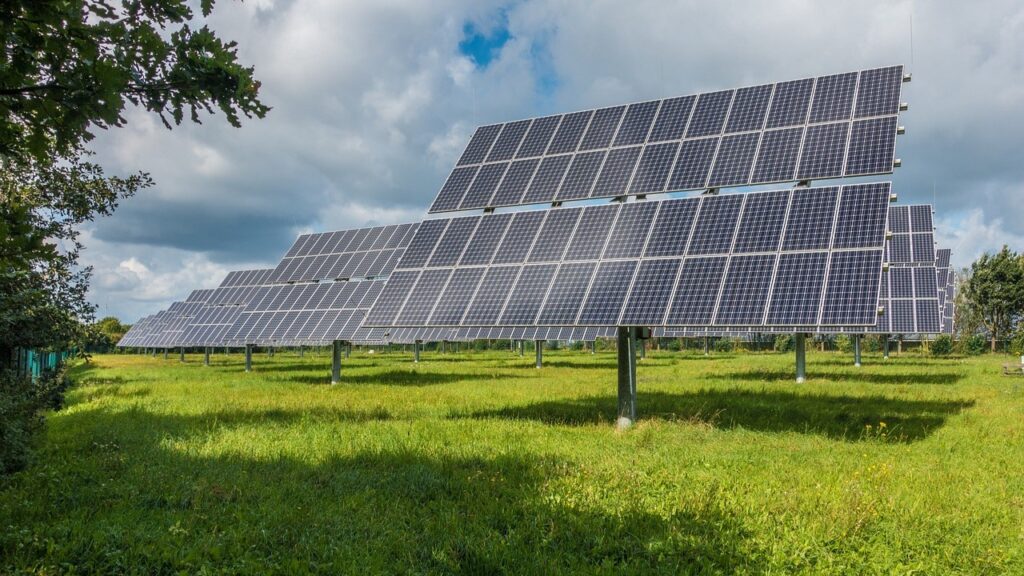Large solar panels on poles in a green field