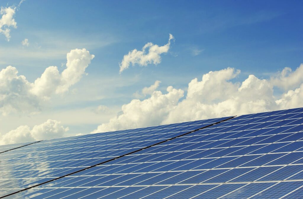 Solar panels below a clear blue sky