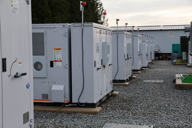 A row of BESS units lined up outdoors